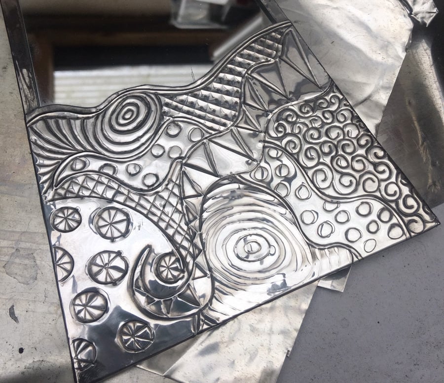 Abstract pewter mirror.