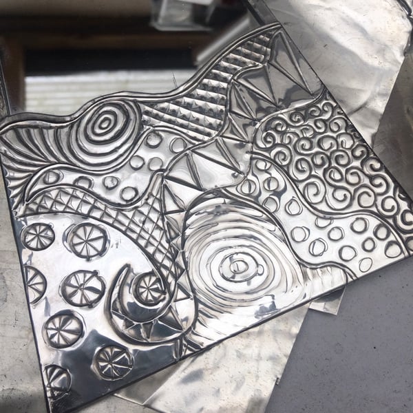 Abstract pewter mirror.