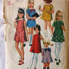 A vintage sewing pattern for a girl's dress in size 12 (Simplicity 8621)