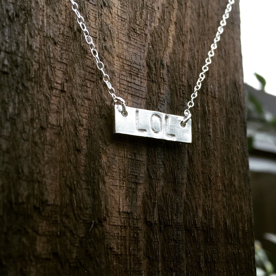 Sterling silver necklace with 'lol' bar