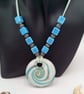 White Glass Pendant with Gold and Blue Cosmic Swirls on a Beaded Necklace - Image 5