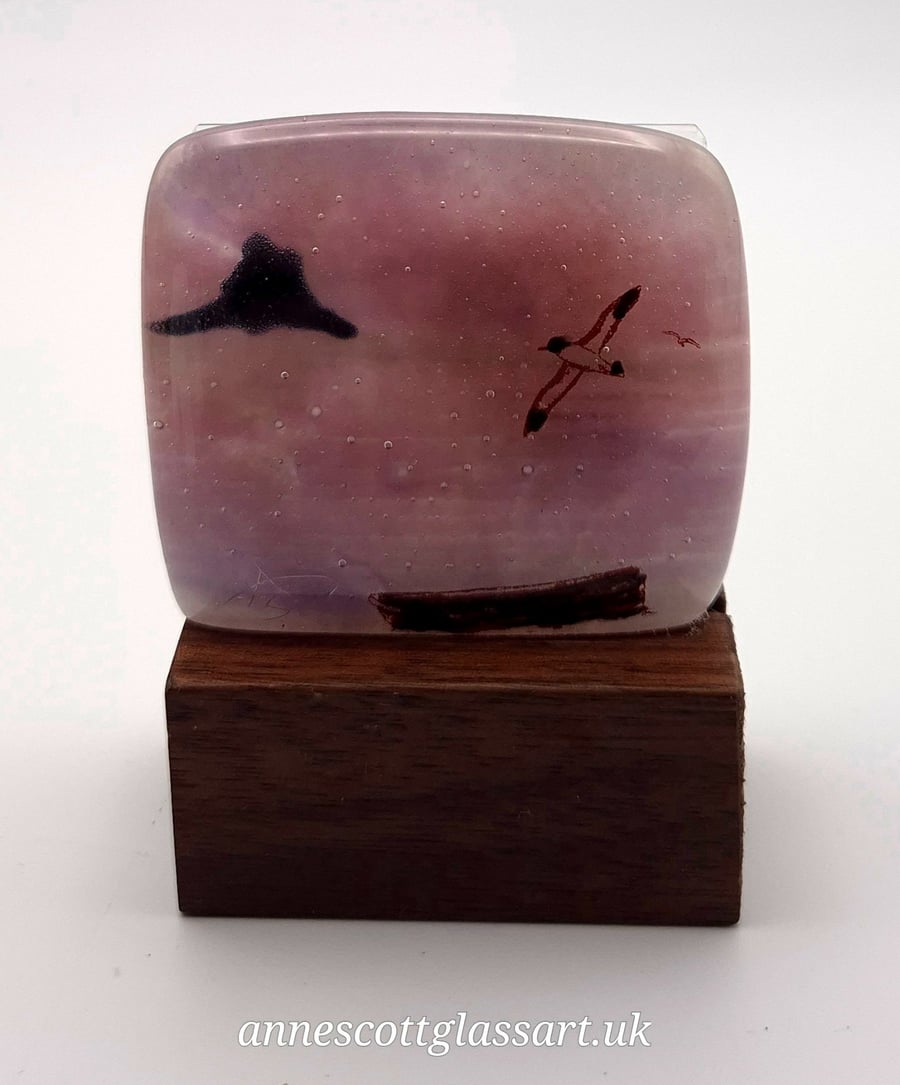 Image of Holy Island on Pink Fused Glass Panel on Block