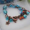 Turquoise & orange splash charm bracelet