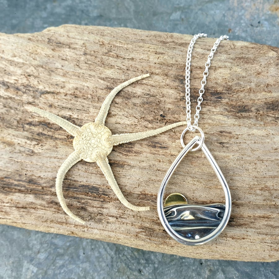 Silver teardrop sun rising over the sea pendant