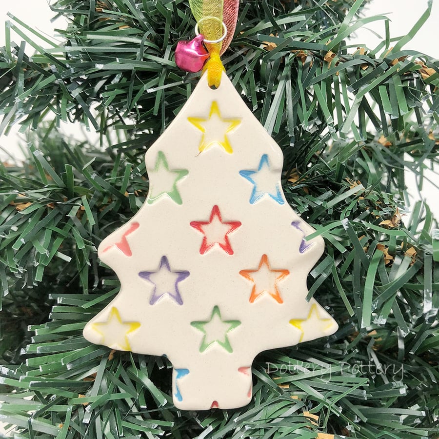 Ceramic Christmas tree decoration with bright stars and a little bell