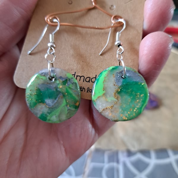 Pair of circular green, white, silver and gold earrings
