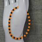 UV Reactive Orange Glass and Dark Metal Bead Elastic Bracelet