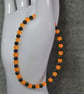UV Reactive Orange Glass and Dark Metal Bead Elastic Bracelet