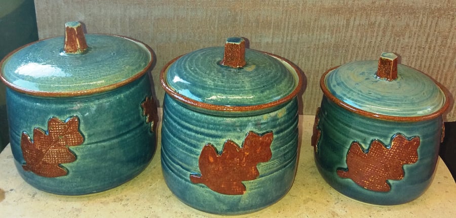 Ceramic, oak leaf decorated storage jars
