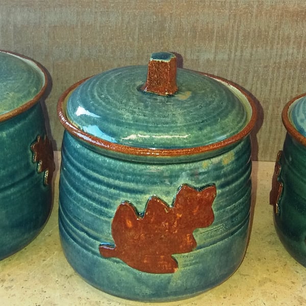 Ceramic, oak leaf decorated storage jars