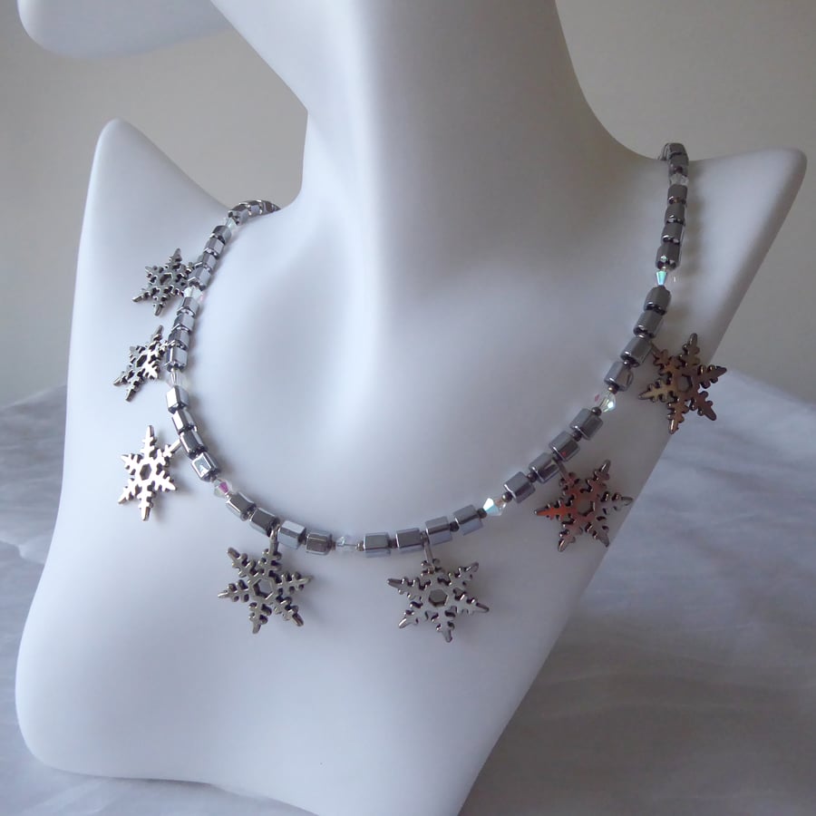 Cube and Faceted Bicone Beaded Necklace with Seven Dangling Metal Snowflakes  