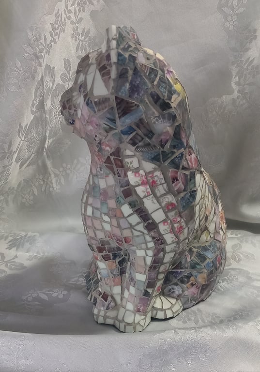 Mosaic-altered vintage ceramic cat figurine.
