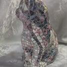 Mosaic-altered vintage ceramic cat figurine.