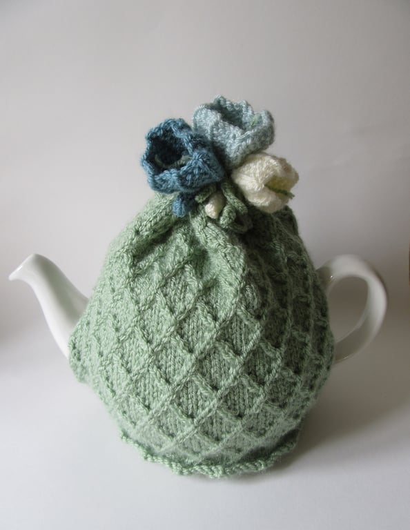 Tea cosy tea cosie - pastel green garden trellis with crocus flowers 