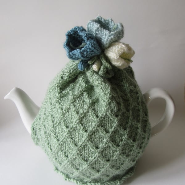 Tea cosy tea cosie - pastel green garden trellis with crocus flowers 
