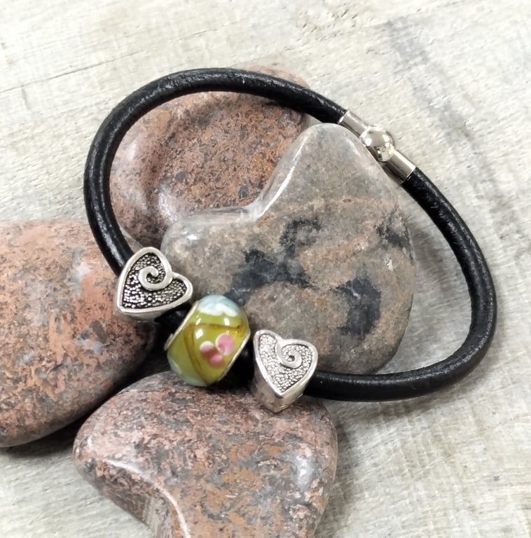 Black leather bracelet with glass bead and hearts.