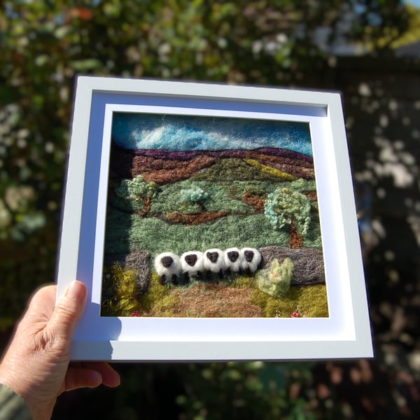 Sheep by a dry stonewall wool painting.  Needlefelt picture with hand embroidery