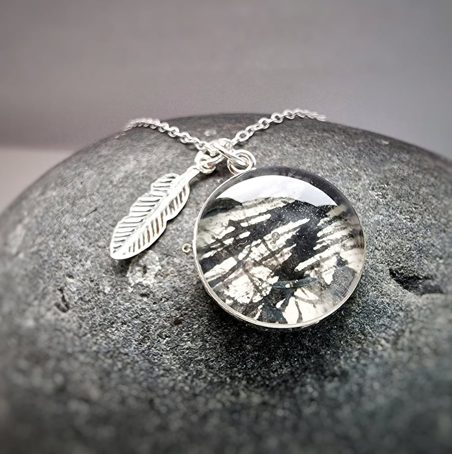 Beautiful sterling silver and resin pendant with  silver feather charm