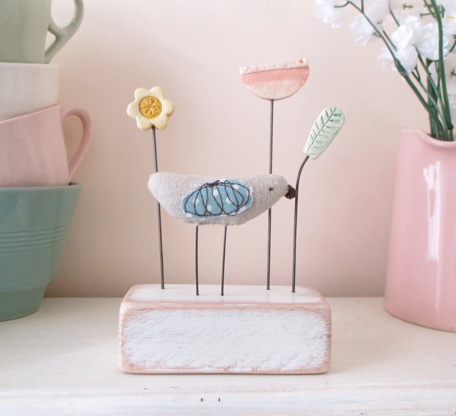 Little Fabric Bird with Two Clay Flowers and a Leaf