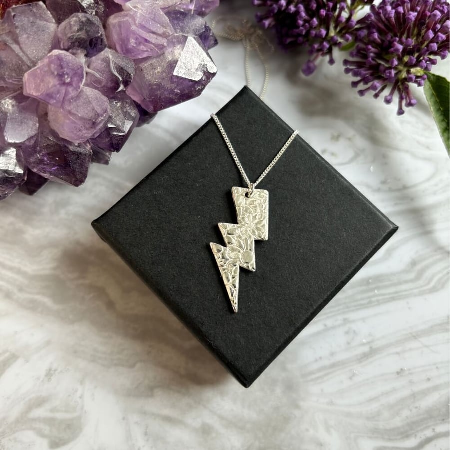 Sterling silver lightning bolt pendant on a sterling silver chain.