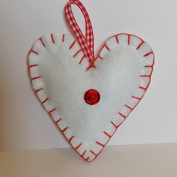 Handmade white felt heart with red stitching, ribbon and button 