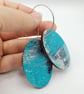 Oval shaped earrings in a watery effect print, blues, white, grey and pink - Image 3