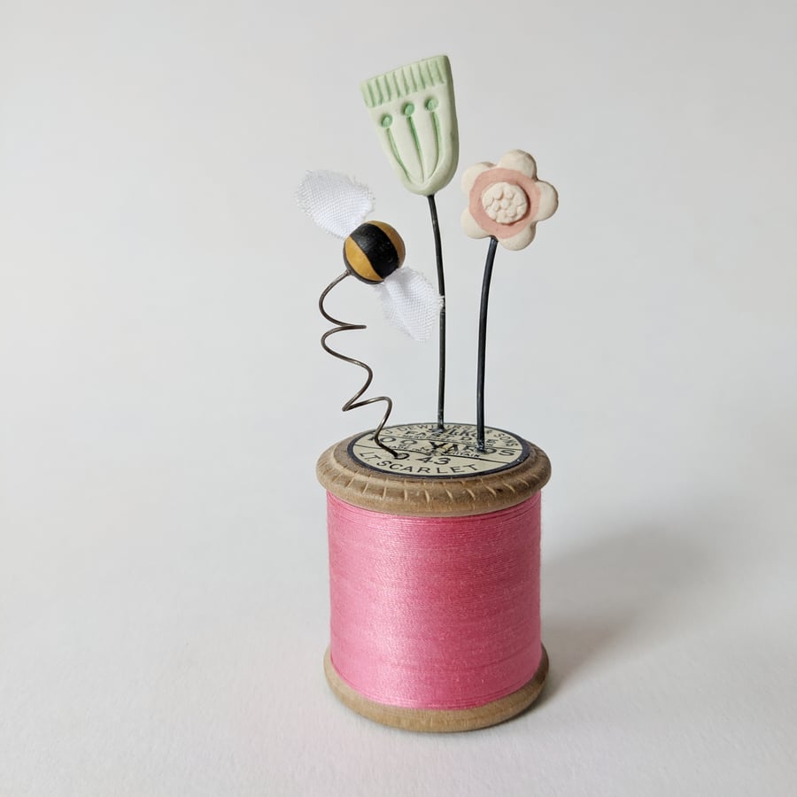 Clay Flowers and Bee on a Vintage Bobbin