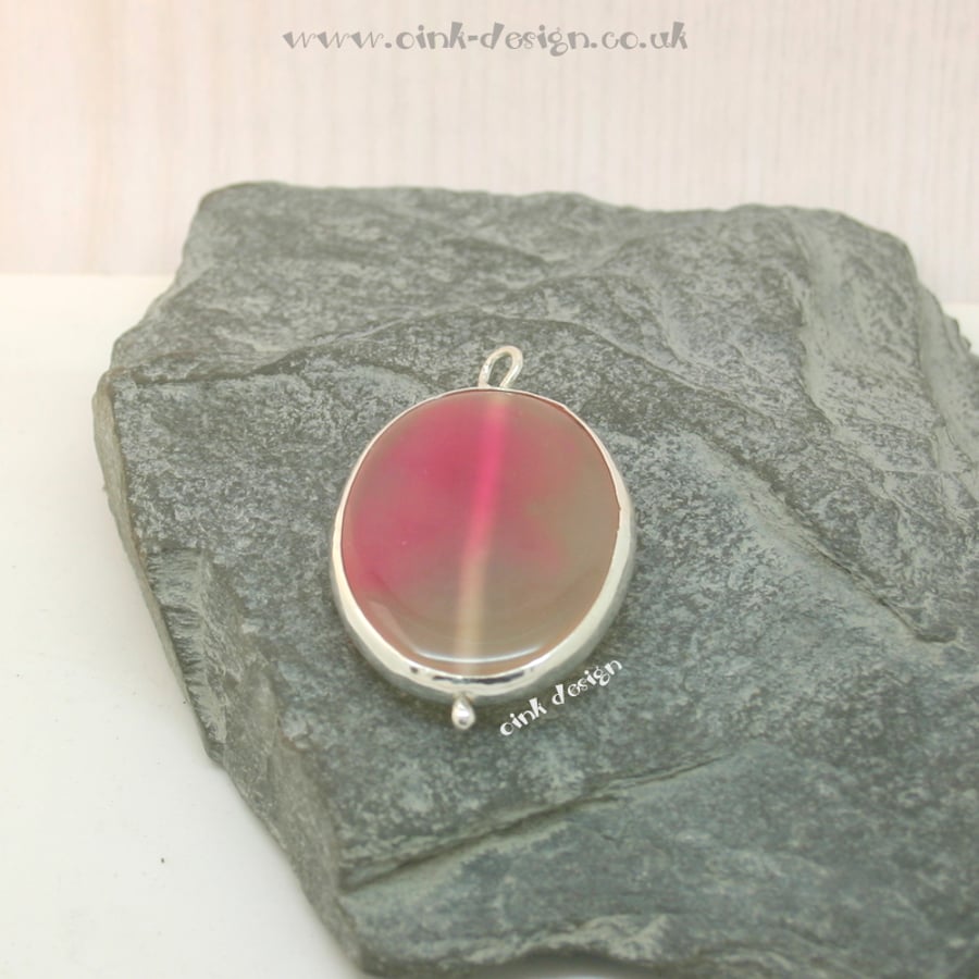 A slice of pink and transparent cream agate set in sterling silver