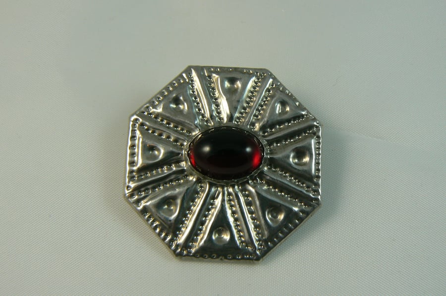Pewter brooch with red stone
