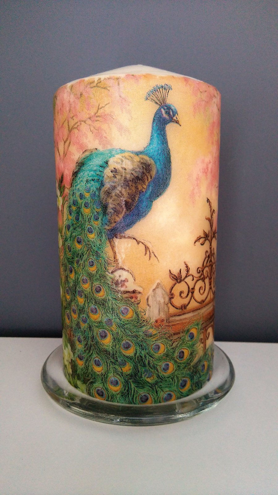 peacock decorated candle