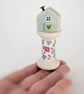 Little Wooden House on a Floral Wooden Bobbin 