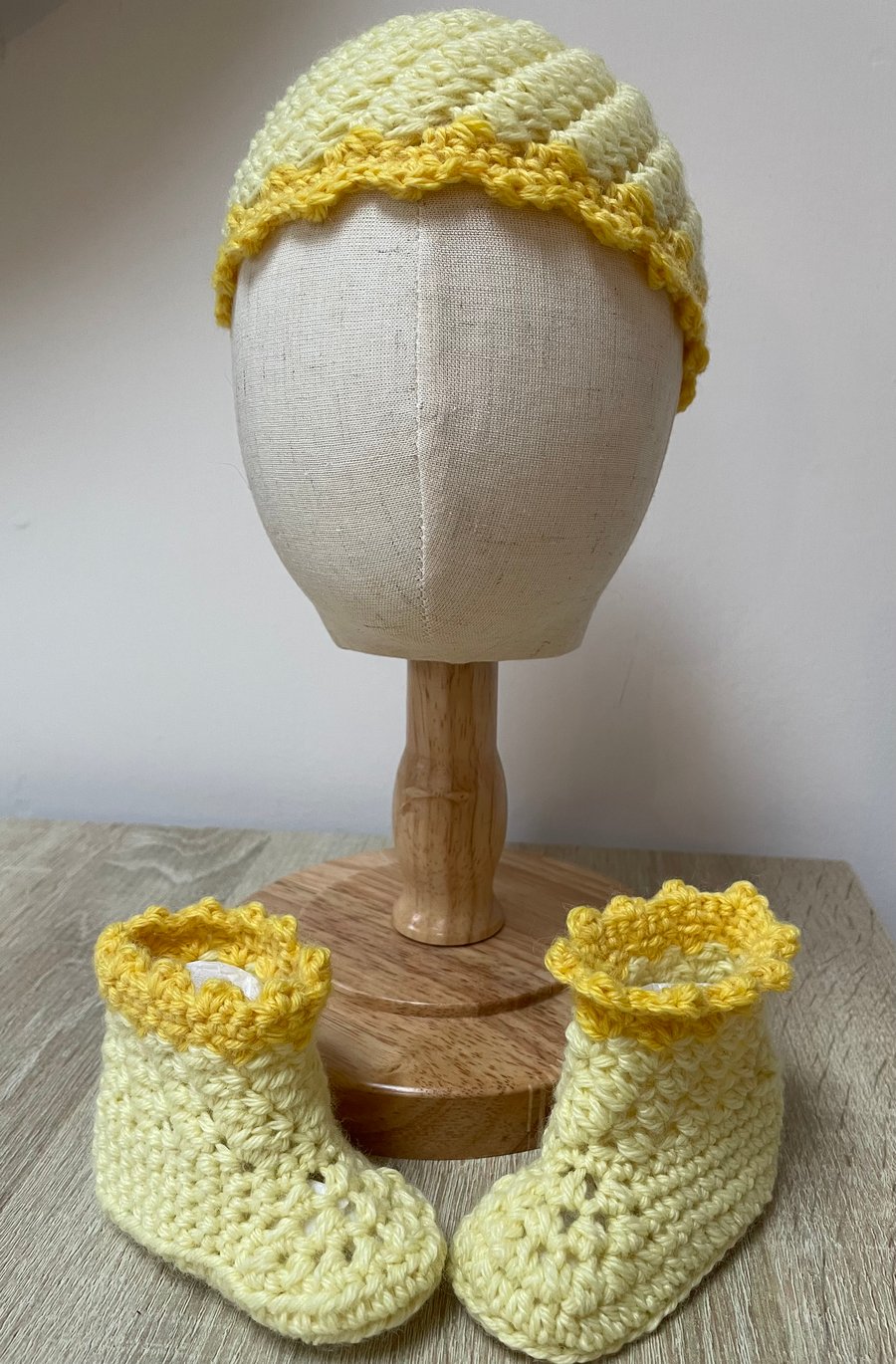 Yellow baby hat and bootie set.