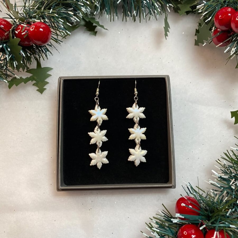 Snowflake triple dangle polymer clay earrings on sterling silver ear wires.