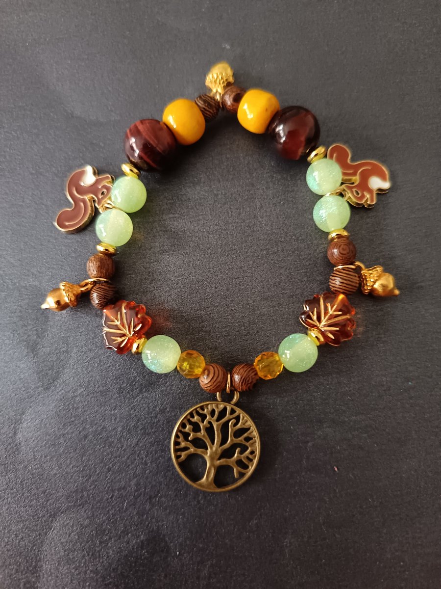 Elasticated beaded red squirrel, tree of life and gold acorn charm bracelet 
