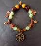 Elasticated beaded red squirrel, tree of life and gold acorn charm bracelet  - Image 1