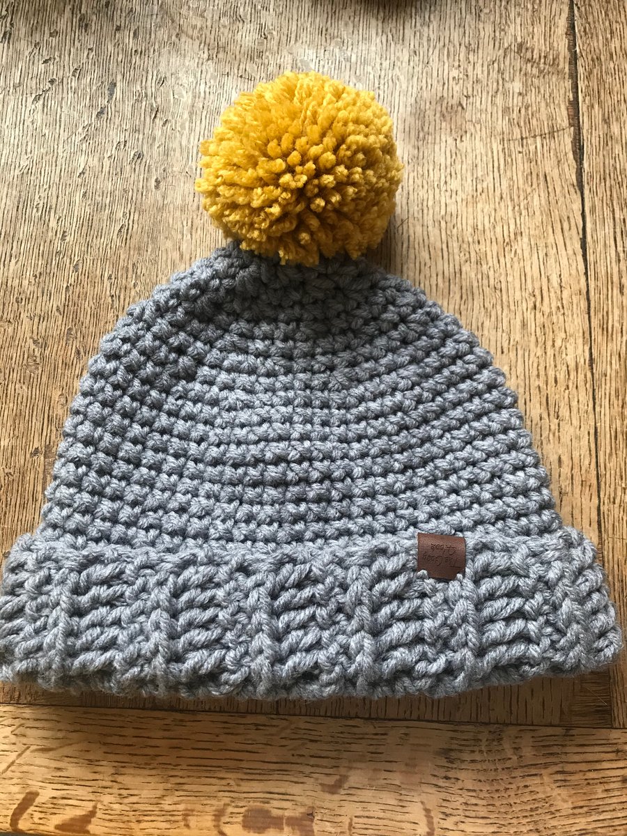 Ladies Grey Crocheted Hat With Mustard Pompom 