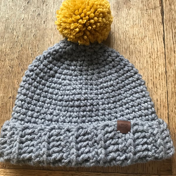 Ladies Grey Crocheted Hat With Mustard Pompom 