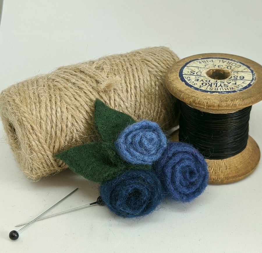 Small felted roses brooch in shades of denim blue