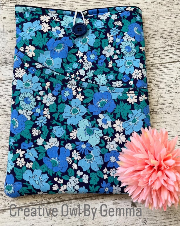 Fabric book sleeve with pocket for paperback books. Padded and fully lined.