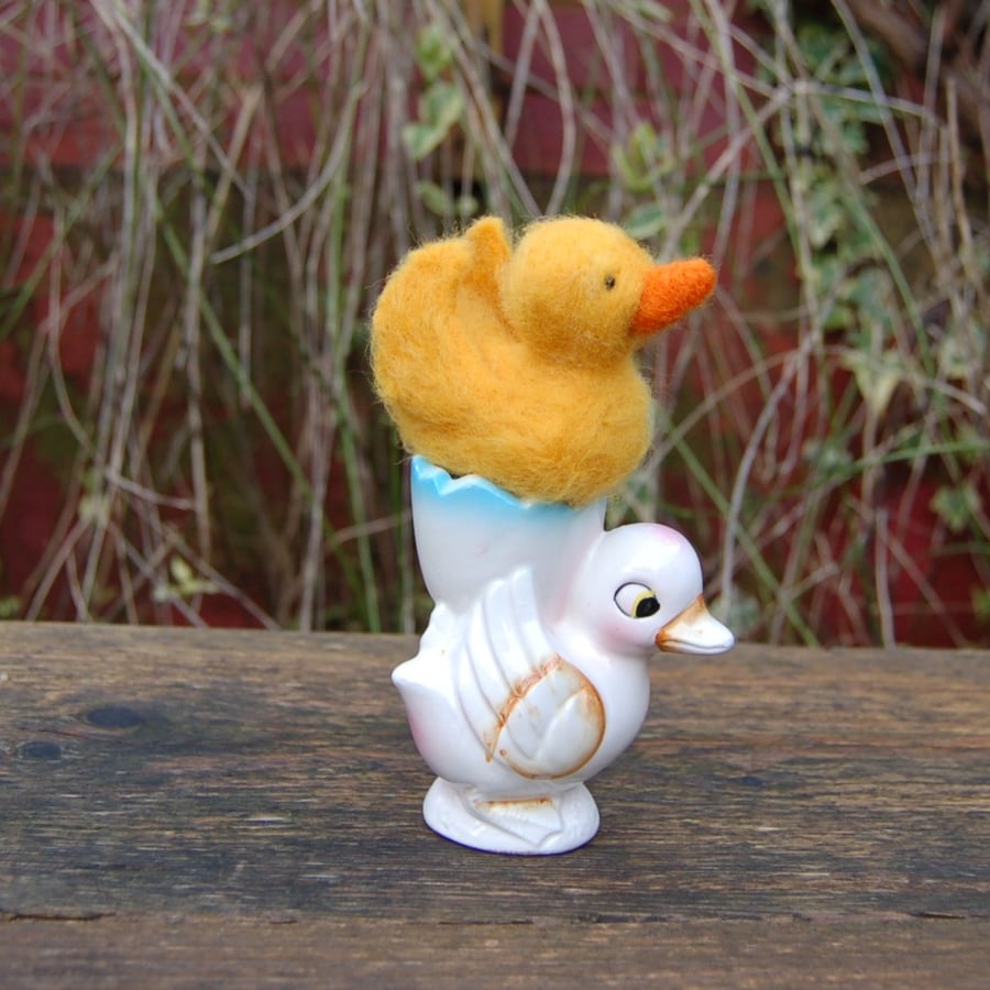 Needle felt duckling displayed in a vintage duckling egg cup 