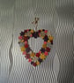 Flower wreath decorated with warm colours and embellished with sequins. - Image 2