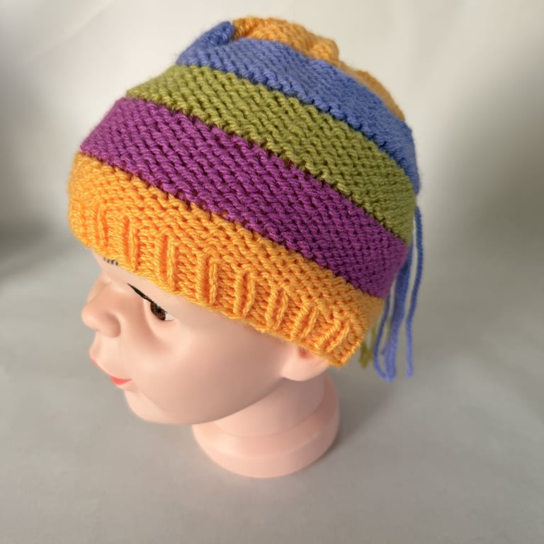 Children's hand knitted rainbow stripe hat with drips