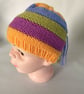 Children's hand knitted rainbow stripe hat with drips