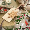 Set of five little wooden Christmas gift tags featuring snowflakes. 