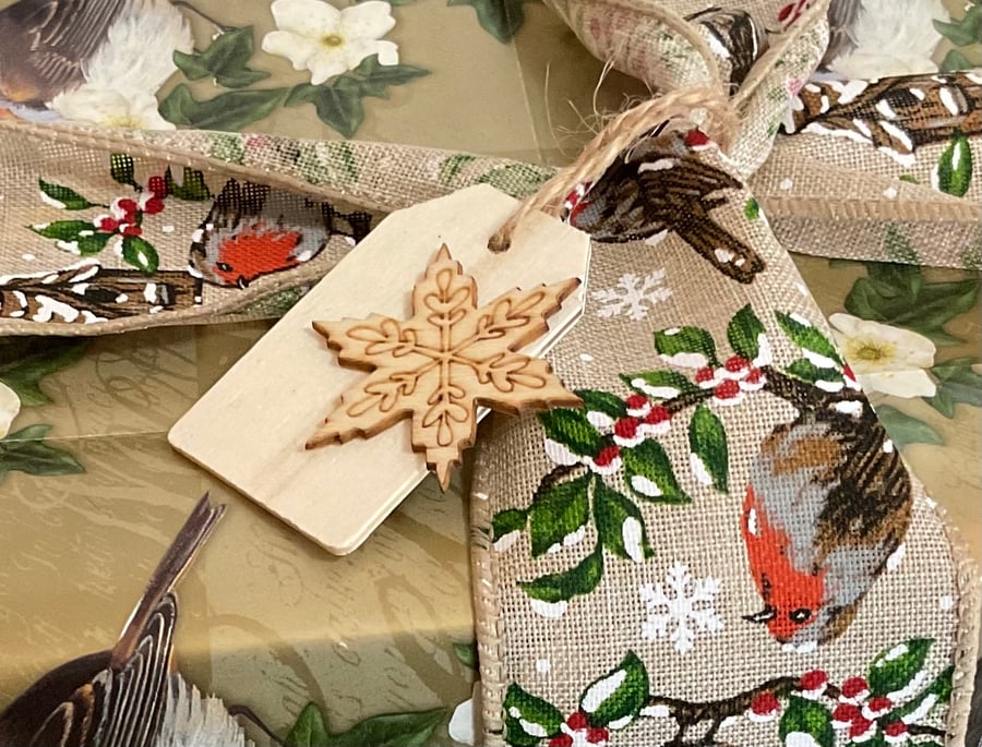 Set of five little wooden Christmas gift tags featuring snowflakes. 