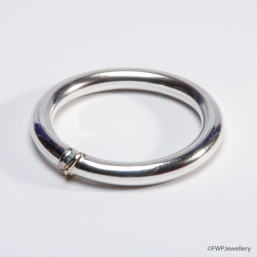 Silver tube bangle with gold accent