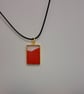 Handmade epoxy resin red and clear rectangular pendant on  black waxed cord