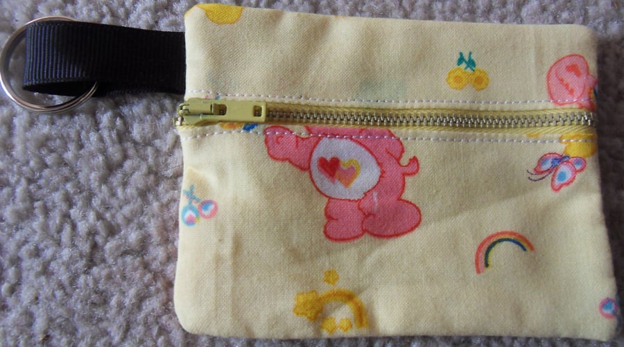 Carebears coin purse. Yellow, approx measures 3 half" x 3"