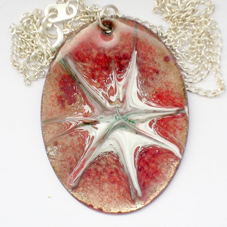 large oval pendant - scrolled white starburst over red