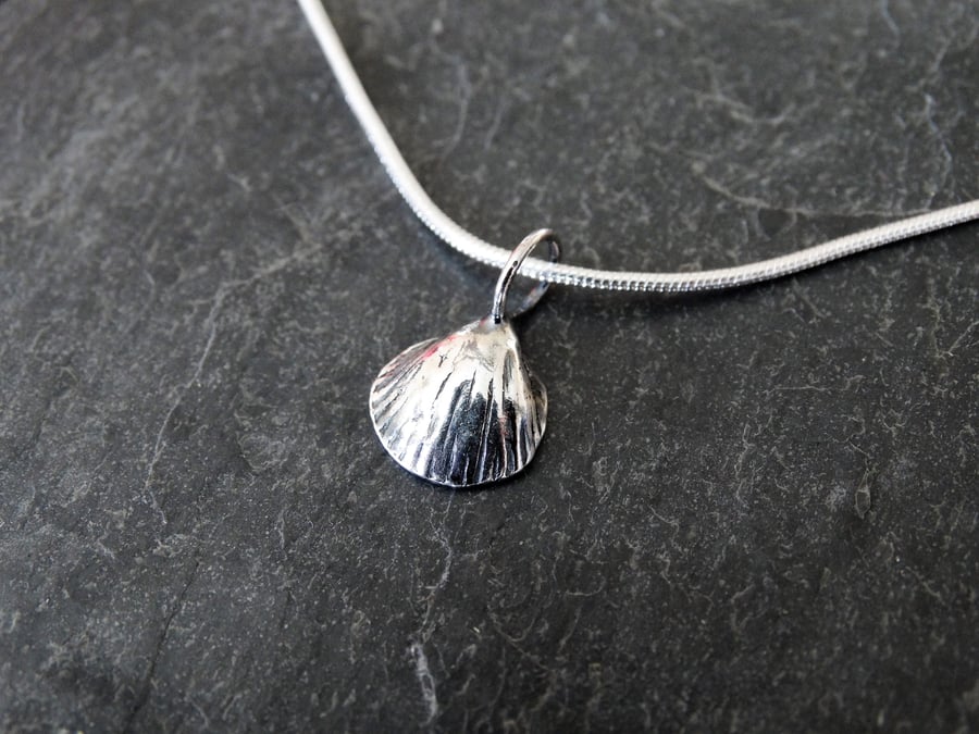 sterling silver cast of a cockle shell, with oxidisation